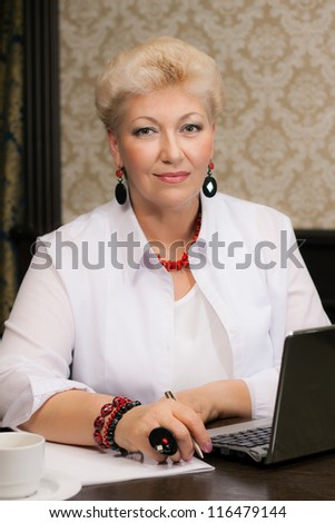 elegant woman with jewelry works at office