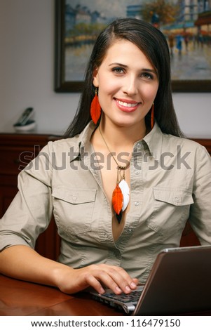 elegant young woman with jewelry works at office