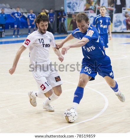 MOSCOW - JUNE 2, Russian Futsal championship, play-off games Dinamo vs. Sinara, final on June 2, 2011 in Moscow. Badretdinov (Dinamo) is trying to tackle a ball from his opponent