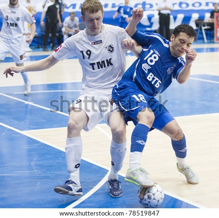 MOSCOW - JUNE 2, Russian Futsal championship, play-off games Dinamo vs. Sinara, final on June 2, 2011 in Moscow. Fernando (Dinamo) is struggling for a ball against Agapov (Sinara)