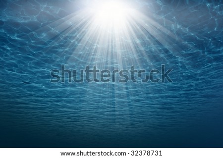 Underwater scene with rays of light and ripple
