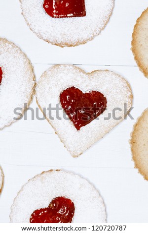 linzer homemade cookies with heart shape raspberry jam window, on white wooden backdrop
