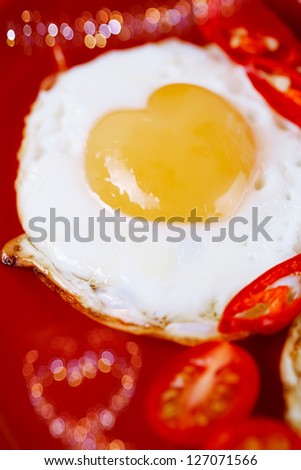 fried egg with heart shape yolks and heart shaped bokeh, lovely breakfast