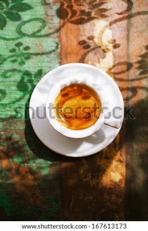 espresso coffee cup on rustic table with sun light and shadows