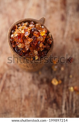 Gum arabic, also known as acacia gum - in wooden mug