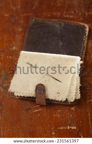 Vintage leather  Needle Book on old table, shallow dof