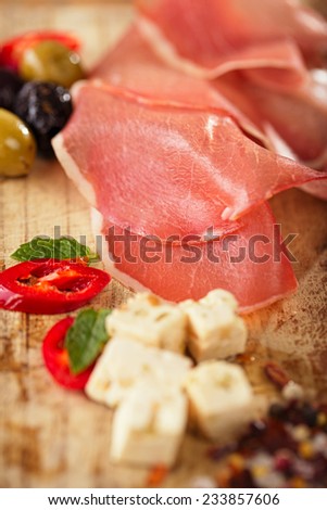 meat platter of Cured Meat and olives on old wooden board