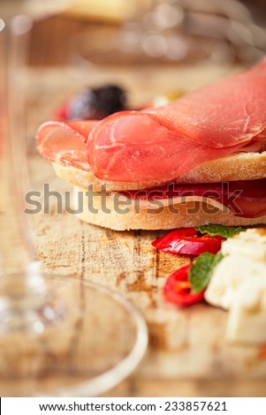 meat platter of Cured Meat and olives on old wooden board