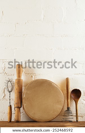 mashers retro kitchen utensils  on old wooden table in rustic style