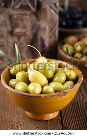 marinated Olives in bowls with moroccan  ornament on wood, shallow dof