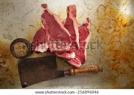 beef steak t-bone with vintage butcher cleaver knife