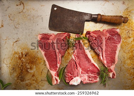 beef steak t-bone with vintage butcher cleaver knife