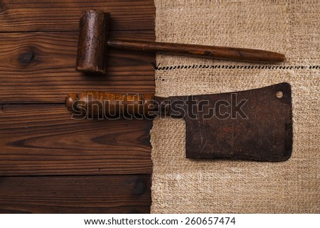 real vintage wooden mallet and iron meat cleaver on old grain sacking linen Completely hand made  handwoven and homespun