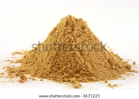 a one pile of ground ginger on white, bright yellow color, sharp shot.