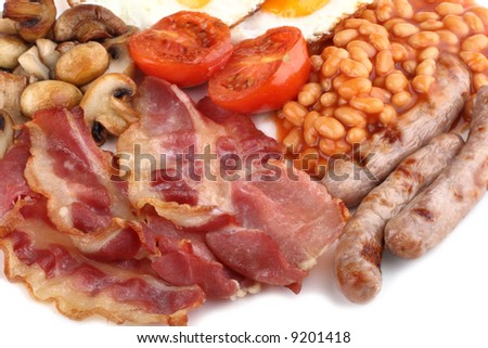 Traditional English breakfast - tomatoes, fried sausages, bacon, mushrooms, eggs and tomato baked beens, close-up, on white, soft shadow