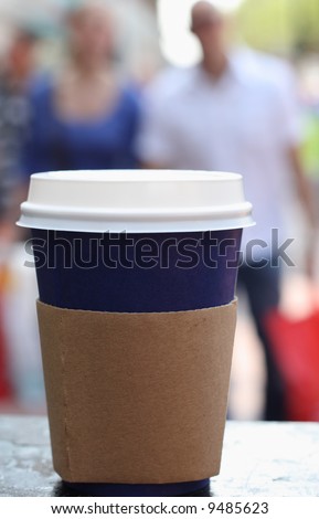 blue coffee cap with lid on a street people background