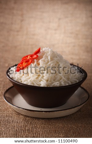 rice bowl with fresh chillies on brown rustic background, Low Key Lighting Technique, Shallow DOF