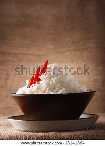 rice bowl with fresh chillies on brown rustic background, Low Key Lighting Technique, Shallow DOF