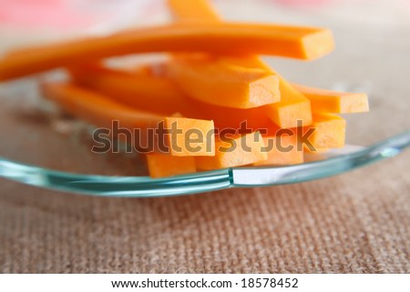carrot sticks on a glass plate and hessian background, shallow DOF