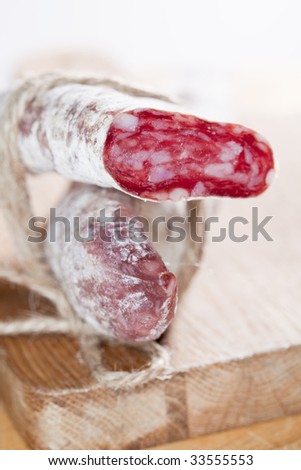 spanish fuet salami cuts tied by string, closeup, shallow DOF
