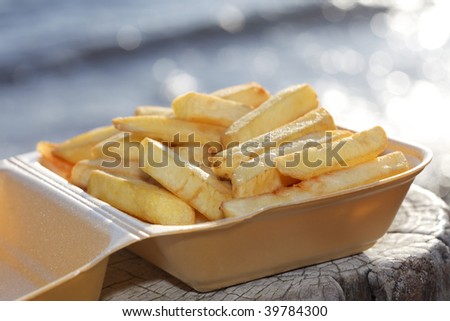 potato fries in take away box on a sea  sea  beach