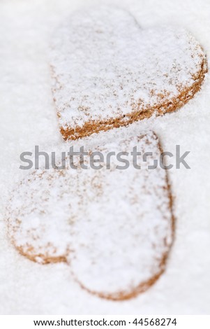 two heart shaped cookies on sugar, very shallow DOF