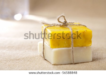 natural homemade herbal soap bars tied, on jute backdrop