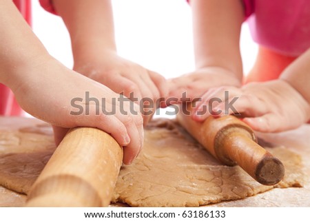 two little girls with rolling pins baking and having fun, hands only