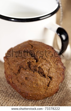 soft ginger cookie with milk in white enamel mug, shallow dof