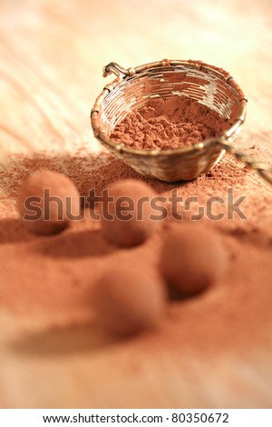 chocolate truffles cocoa powder dusted and sieve, shallow dof
