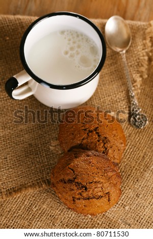 soft ginger cookies with milk in white enamel mug, shallow dof