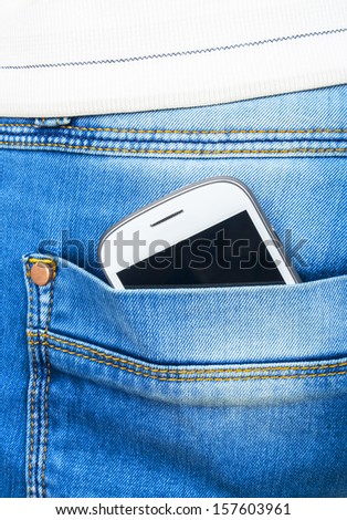 Mobile white phone in blue jeans pocket
