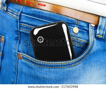 Mobile black phone in blue jeans pocket