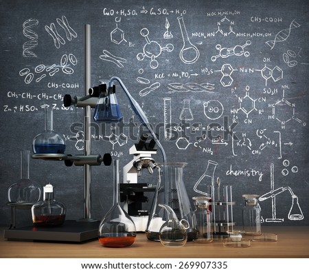 Chemistry laboratory concept. Laboratory chemical test tubes and objects on the table with chemistry draw on whiteboard.