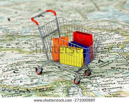 International shopping. Colorful package in the shopping cart on the world map. World trade concept.