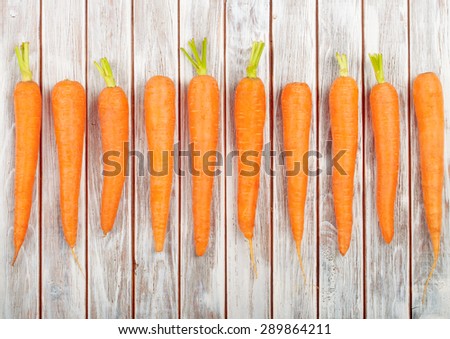 Fresh Organic Carrots isolated on wooden background