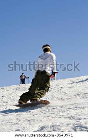 Men descending mountain in a snowboard