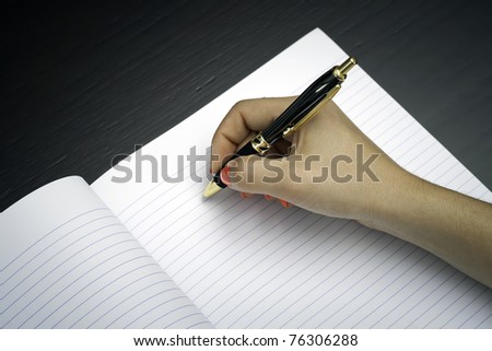 Woman about to write on a black note paper