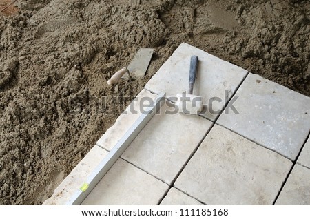 Installation of big stone tiles on the floor