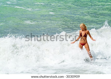 Youing woman play in waves