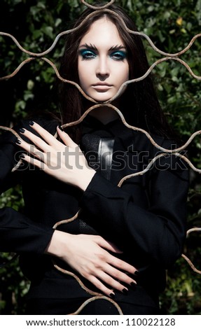 Religious female leaning on convent lattice. Fashion conventual woman posing outdoors.Grace