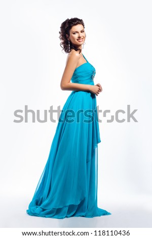 Feminine. Gorgeous graceful smiling brunette girl in elegant blue prom dress