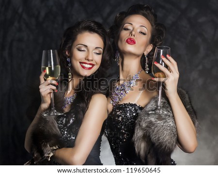 New Year\'s Eve of two beautiful young women with wine glasses