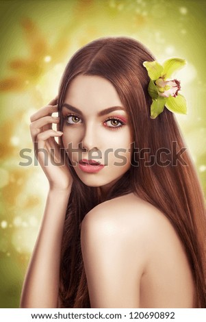 Beauty Portrait Brunette Model with Healthy Straight Hair with Flower