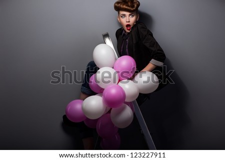Woman on Steps Ladder with Air Balloons Having Fun