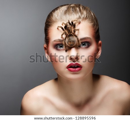 Scary Arachnid Predator on Beauty Woman Face sitting