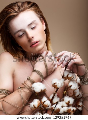 Fantasy. Emotions. Fashionable Young Long Hair Man with Flowers