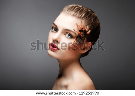 Portrait of Woman with brachypelma smithi Big Spider creeping on her Face