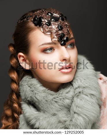 Braided Hair Luxurious Woman in Fur Collar and Gemstones. Jewels