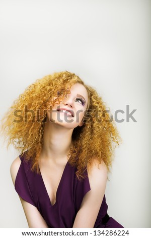 Lifestyle. Radiant Happy Woman with Curly Golden Hairs smiling. Positive Emotions